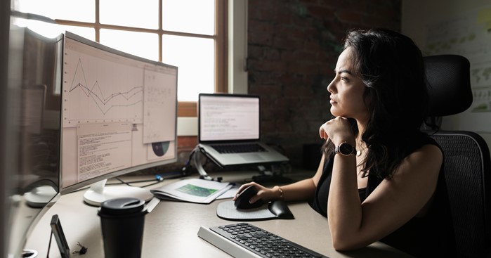 Kvinna vid datorn analyserar grafer